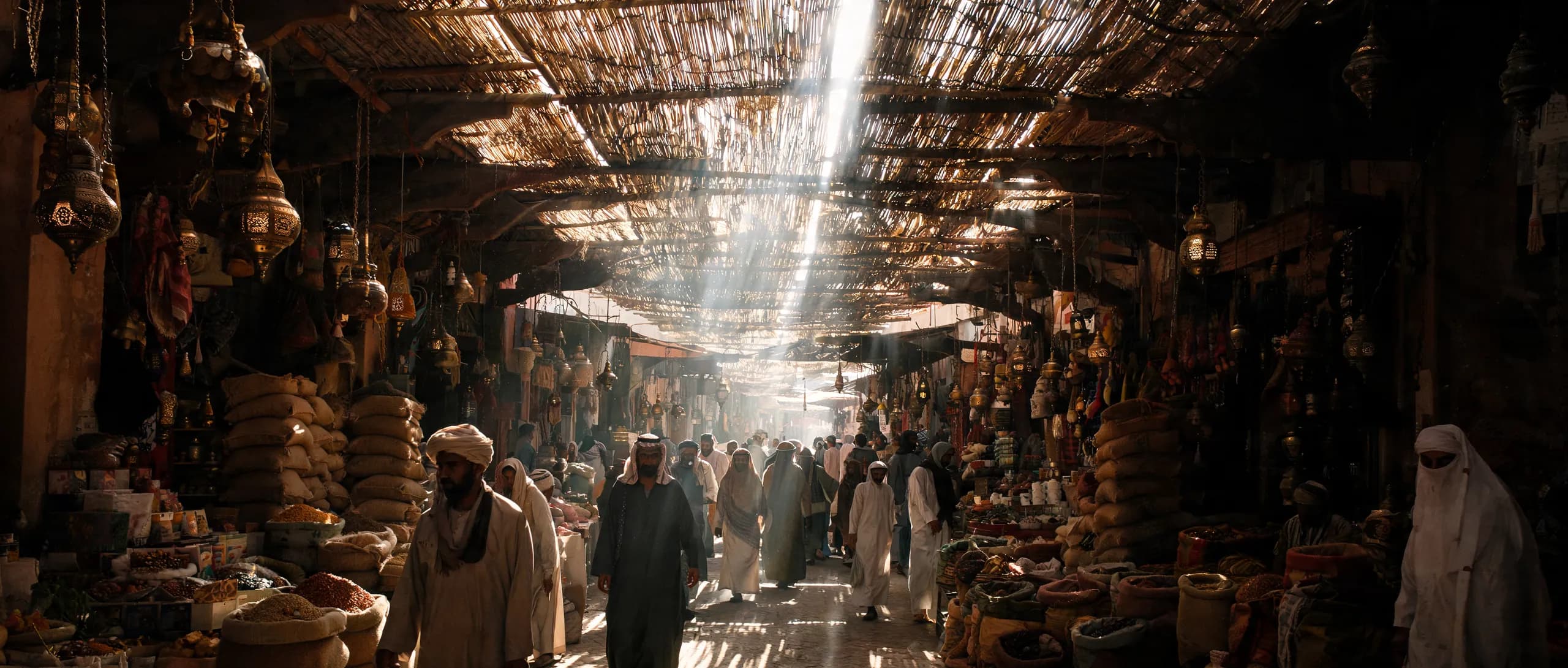Sunlight cutting through the roof of a covered souk in the medina
